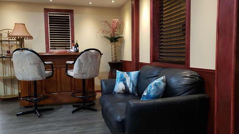 Home bar with a leather couch