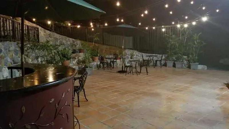 Outdoor café at night under dimmable Edison string lights