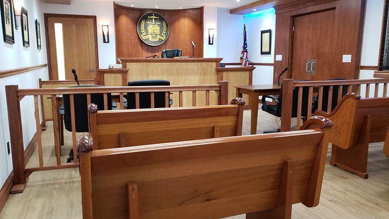 Courtroom overview with judge's bench, counsel tables, and gallery seating