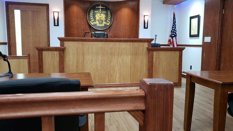 Close view of the judge's bench with wood detail and gavel area