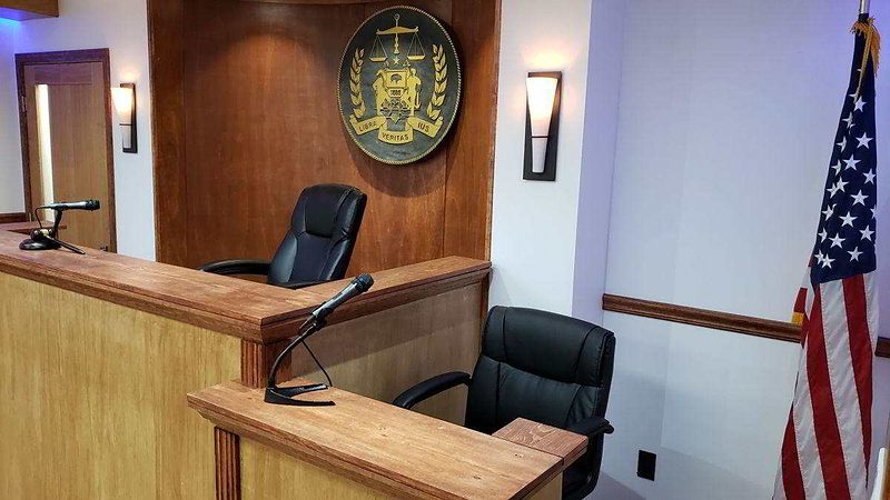 Witness stand with rail and microphone position