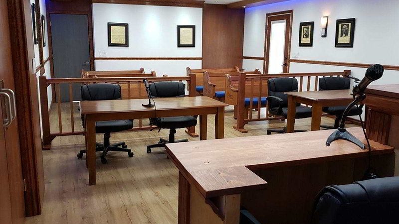 Camera view from the witness stand toward counsel tables and gallery seating