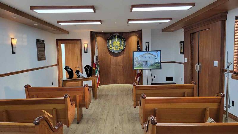 Courtroom space with judge's bench removed, staged as a federal auction