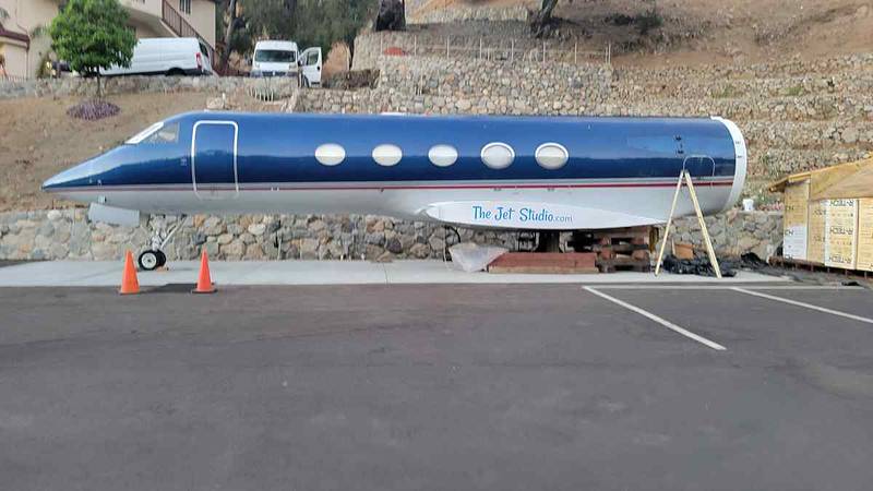 Private jet fuselage on its stage by day