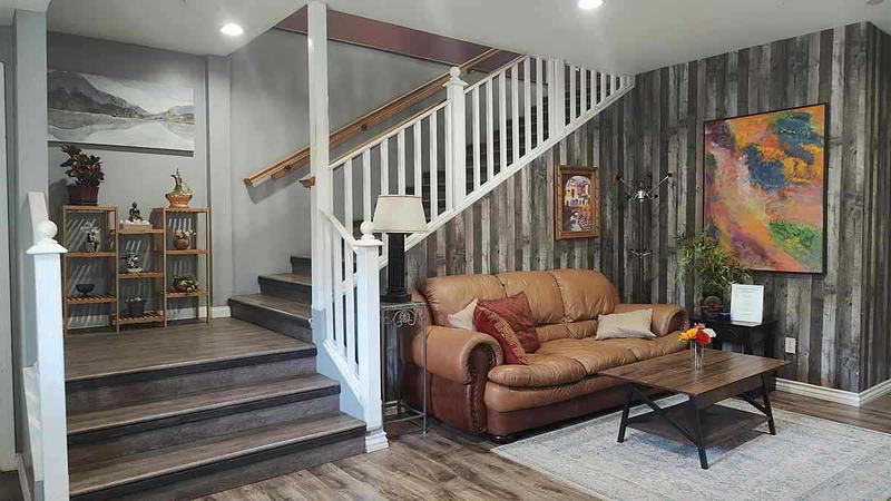 Entry living room with a sofa and staircase