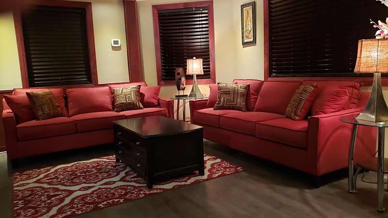 Main living room with bay windows and dark wood blinds
