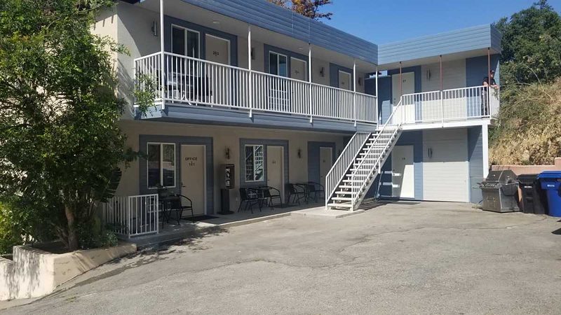Motel and apartment building exterior by day