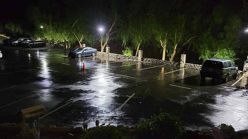 Lower parking lot at night, wet down for a just-after-rain look