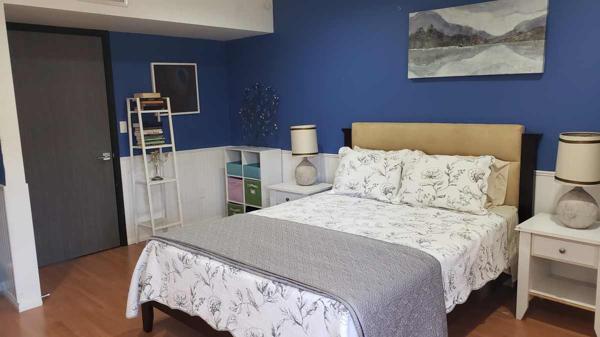 Smaller bedroom with door to balcony.