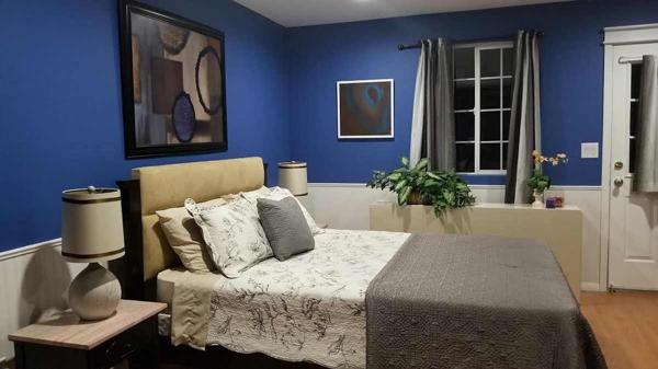 Smaller bedroom with door to balcony.